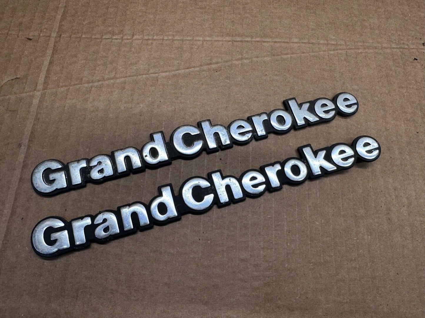 93-98 Jeep Grand Cherokee OEM 55295445 Metal Emblem Pair Set Front Fender Badge